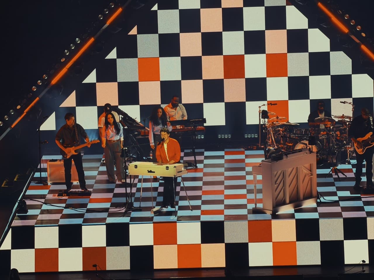 A concert performance on a checkered stage