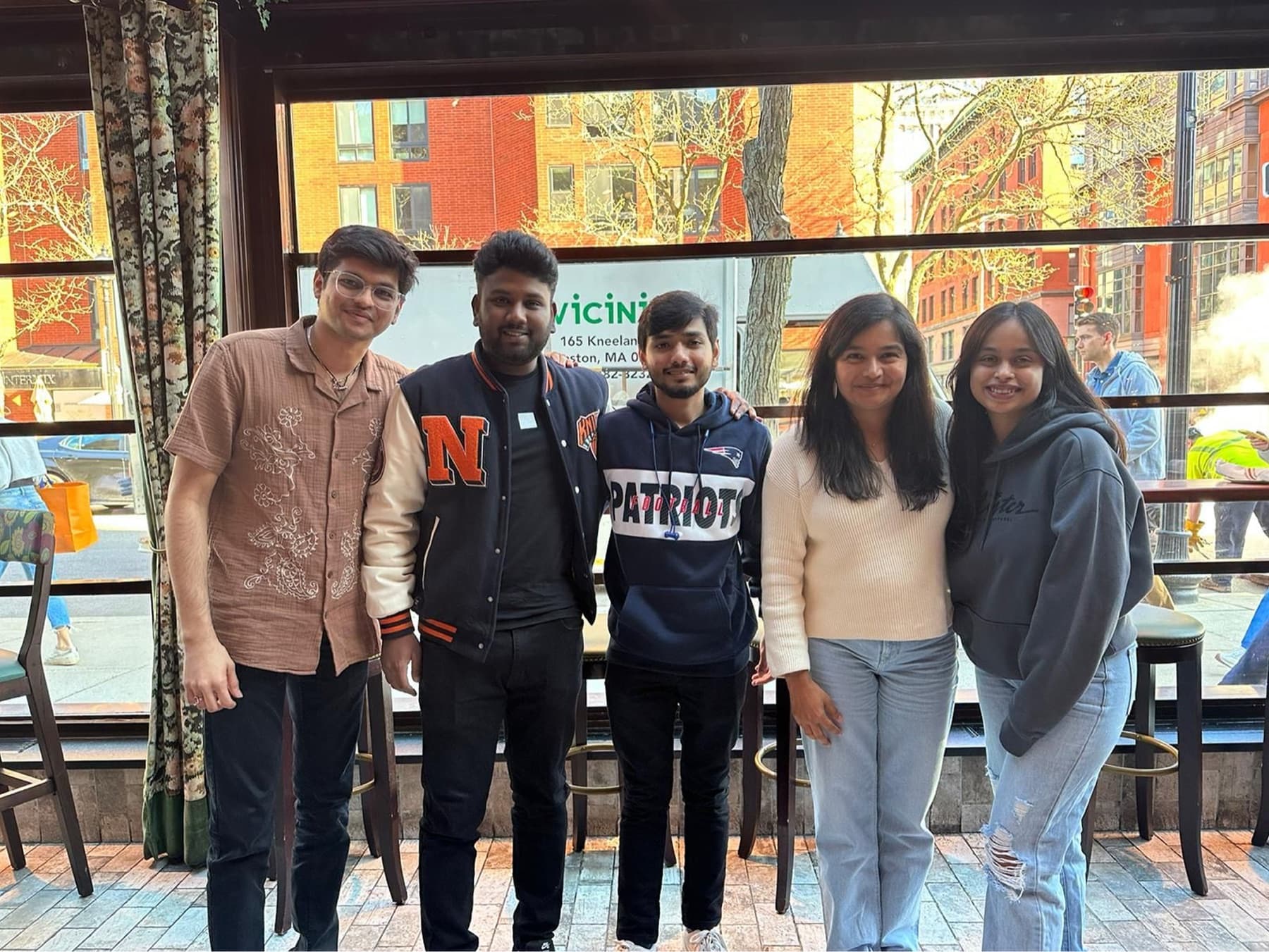 The team of five standing together in Boston
